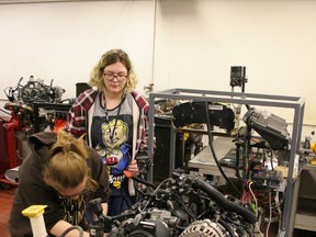 Amber La Brecque (Ecole Heritage) and Lee Guerette (Ecole Quatre Vents) work at testing compression on a v-8 engine in the GPRC Fairview College Campus Automotive Technology shop during the Trades and Technology Camp held at the college May 3-4.