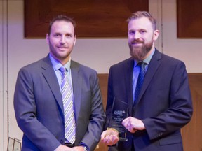 Allan Lovett (right) is presented the Young Alumnus of the Year 2018 Awards Citation by Wilfrid Laurier University Alumni Association president Marc Richardson. (Adamski Tomasz Photography)