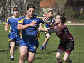 Andrew Plumstead of Paris District High School tries unsuccessfully to stop BCI ball carrier Eric Patterson during a senior boys rugby match on Tuesday in Paris. (Brian Thompson/The Expositor)