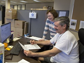 Returning officer Julia Jacobson and logistics election officer Rick Levac work on setting up the Brantford-Brant riding returning office, located at 225 Henry Street, Buillding 1 in Brantford. (Brian Thompson/The Expositor)