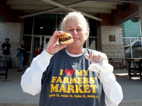 Glenda Smith of Smith’s Cheese enjoys a slider on the first day of the outdoor farmers’ market at Covent Garden Market Saturday. (CHRIS MONTANINI\LONDONER)