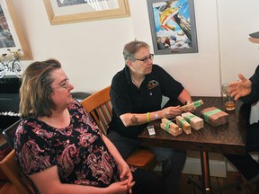 Sam's Percolator owner Mary Anne Butler, pen maker Linda Nicholson and furniture designer Michael Knight discuss the woodblocks Knight donated to Nicholson inside Butler's restaurant on April 21. Tom Morrison/Chatham This Week