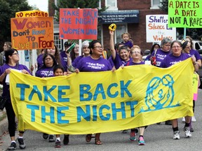 Take Back the Night participants march down Brock Street in September 2017.