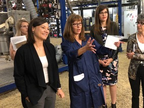 Environment and Parks Minister Shannon Phillips, left, tours a pilot plant facility operated by Enlighten Innovation in Fort Saskatchewan, Alta. on May 8, 2018. Supplied Image/Government of Alberta