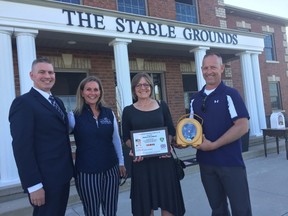 Patrick Armstrong, left, Rachel Webber (founder of The Stable Grounds), Debbie Broadbent and Kevin Webber (founder of The Stable Grounds) were at The Stable Grounds in Rodney Tuesday for the Dave Mounsey Memorial Fund’s defibrillator donation in honour of Rob Broadbent, chief of the St. Thomas fire department, who died in August. (Laura Broadley/Times-Journal)