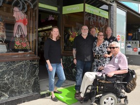 A project to install free accessibility ramps at downtown business entrances kicked off Wednesday at Dr. Cobbler Shoes and Swirls. Project working group member Christine Farrell, left, proposed implementing the StopGap Foundation project in the city. Shopkeepers Ron and Camille Cole, centre, are joined by working group members Andy Underwood in his wheelchair, and behind them, Fraser Lines and Jim McManaman. Scott Dunn/The Owen Sound Sun Times/Postmedia Network