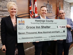 Luke Hendry/The Intelligencer
Erin Rivers, director of community and human services for Hastings County, and committee chairman Garnet Thompson, right, flank Grace Inn’s Jodie Jenkins to present the shelter with a cheque for $7,908 Wednesday at county headquarters in Belleville. Grace Inn is to open in Belleville’s former Irish Hall by year’s end.