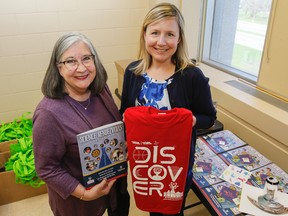 Science Rendezvous Kingston organizers Lynda Colgan, left, and Kim Garrett show off the 2018 program, schedule and take-home experiments that will be available to the first 2,000 families through the Rogers K-Rock Centre doors on Saturday. (Julia McKay/The Whig-Standard)