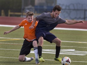 Brad Erskine (left) of North Park Collegiate vies for the ball against an Assumption College player during a high school boys quarter-final game on Wednesday at Kiwanis Field. (Brian Thompson/The Expositor)