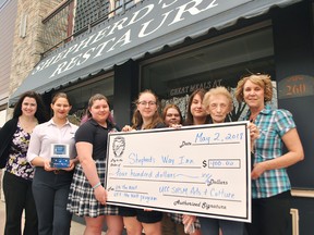 Students in the arts and culture group of the Specialist High Skills Major program at Ursuline College Chatham presented Shepherd's Way Inn with a $400 cheque. Shown are SHSM lead Kathryn Lacina, students Ceili Smith, Madison Howes, Isabelle LaMarsh, Emily Sparling, Julia Tanguay, Shepherd's Way operator Teresa Nadeau and SHSM lead Mary Lynne Martin. Tom Morrison/Chatham This Week