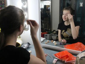 Katie Friesen-Kroeker applies her own make-up before getting into costume for the Friday, May 4 evening show of The Butler Did It. Photo by SHERI LAMB/Daily Miner and News/Postmedia Network