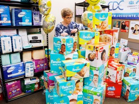 Luke Hendry/The Intelligencer
Good Baby Box co-ordinator Bev Heuving stands behind boxes of donated disposable diapers Thursday at the Community Development Council of Quinte office in Belleville. The May 9 diaper drive brought in 10,000 diapers but Heuving had hoped for 15,000. She's now appealing for further donations of cash or diapers.