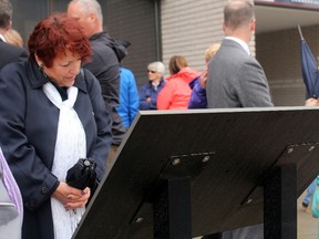 Denise Point examines the memorial plaque unveiled Thursday remembering the 1975 Barry Building explosion. Point's sister, Louise Brousseau, was one of the eight people killed in the disaster.
PJ Wilson/The Nugget