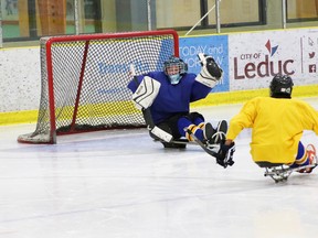 The Fort’s own Tyson Rietveld tries his best to keep the pucks out of the net during practice with Team Alberta’s sledge team in Leduc last weekend. The group was fine tuning their skills before defending their title at the 2018 Canadian Sledge Hockey Championships in Richmond, B.C. starting on May 11.