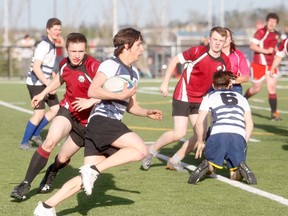 Gordon Anderson/Daily Herald-Tribune
Thomas Diodoro of the Peace Wapiti Academy Titans takes the ball down field against North Peace Secondary School during Peace Country High School rugby play at CKC Field on Wednesday evening. The Titans grabbed a 19-12 win over the visitors from Fort St. John.