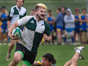 St. John's College ball carrier Ethan Rook keeps moving despite a diving tackle attempt by BCI's Jude Son during a high school senior boys rugby match on Thursday at Tollgate Tech. (Brian Thompson/The Expositor)