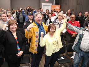 Councillor Jane Stroud has her arms raised after officially being declared the Alberta NDP's Fort McMurray-Conklin byelection candidate at the Unifor 707-A building in Fort McMurray, Alta. on Thursday, May 10, 2018. Alberta's Indigenous Relations Minister Richard Feehan is behind her. Vincent McDermott/Fort McMurray Today/Postmedia Network