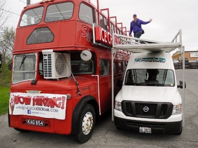 A vintage double-decker bus from England (by way of London, Ontario) is about to open as an ice cream shop on the Queensway East in Simcoe. Installing new signage on the Indulge outlet is co-owner Steve Greer of Ayr. MONTE SONNENBERG / SIMCOE REFORMER