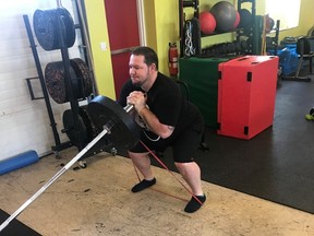 Jan Murphy performs a landmine goblet squat with band for accommodating resistance and anti-foot arch collapse during his training at 247 Fitness with Visionary Fitness owner Farr Ramsahoye.  (Farr Ramsahoye/Visionary Fitness)