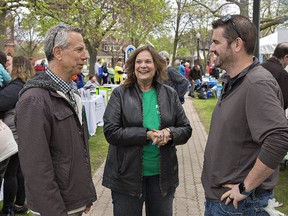 Michael Benin (left), of the Canadian Mental Health Association, Brant-Haldimand-Norfolk, talks with education and promotion team lead Lill Petrella and St. Leonard's Community Services executive director Brad Stark at a Mental Health Week wrap-up barbecue on Friday at Alexandra Park. (Brian Thompson/The Expositor)