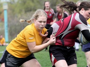 St. Mike's Cassie Van Bakel takes down Northwestern's Claire Lavereau during the girls rugby match Friday afternoon in Stratford. Cory Smith/The Beacon Herald