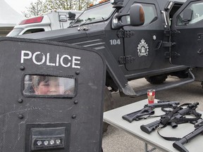 Eight-year-old Carter Margeson of Brantford peers through the window of a ballistic shield at the emergency response team's display on Saturday at the Brantford Police Family Fun Day at the civic centre. 
Brian Thompson/The Expositor