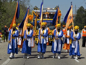 Members of the Sikh community carry flags in the Khalsa Day parade as it makes its way down Park Road North on Sunday in Brantford.
Brian Thompson/The Expositor