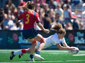 Canada's Breanne Nicholas of Blenheim, Ont., jumps to score a try as Spain's Amaia Erbina looks on during the World Women's Rugby Sevens Series in Langford, B.C., on Saturday, May, 12, 2018. (JONATHAN HAYWARD/The Canadian Press)