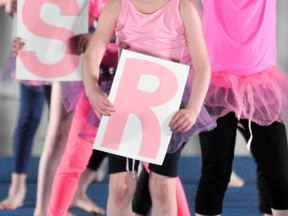 Clare Jacobs (front), holds the letter ‘R’ during the Gymnastics Tuesday Beginner routine of “Respect.” ANDY BADER/MITCHELL ADVOCATE