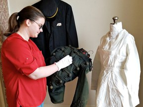 Lillia Dockree, staff member at the Brant Museum and Archives, works on a circa 1880s-style uniform worn by Lt. Col. E. D. Cameron of the Dufferin Rifles, the forerunner of the 56th Field Artillery Regiment, which is part of a new exhibit called Brantford in Uniform mounted in time for International Museum Day on Friday. (Tim Philp/Brant Museum and Archives)