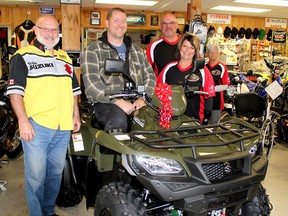 Shawn Daley, second left, now has a new 2018 Suzuki KingCab ATV that he picked up from Bobs Motorsports in Chatham on May 12. Bob Funke, left, owner of Bobs Motorsports, and Suzuki worked with Vince and Jo-Jo Masse of the Chatham-Kent ATV Club, to replace an older ATV that was stolen from Daley's home on Easter Weekend. (Ellwood Shreve/Postmedia Network)