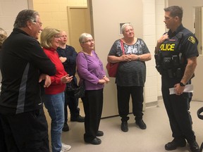 BRUCE BELL/The Intelligencer
Community Services officer Const. Pat Menard of the Prince Edward OPP gives a group of visiting seniors a tour of the detachment’s holding facilities on Tuesday morning. The tour was part of a Morning coffee with Prince Edward OPP.