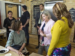 Ontario NDP Leader Andrea Horwath speaks with Paris resident Catherine Stewart during a campaign stop on Tuesday.  At right is Alex Felsky, the party's candidate in Brantford-Brant. (Brian Thompson/The Expositor)
