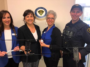 BRUCE BELL/THE INTELLIGENCER 
Alzheimer Society of Hastings and Prince Edward representatives (from left) Morgan Haviland, executive director Maureen Corrigan, Lorraine Ross were at the Prince Edward OPP detachment on Tuesday along with Acting Sgt. Troy Bellehumeur to launch Project Lifesaver. The program is aimed at finding people with Alzheimer’s or other forms of dementia if they wander.