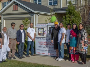 Mayor Peter Brown, Syed Najam with Love with Humanity Association, Shehzad Awam and his wife Mona Shehzad pose with family and friends at the opening ceremony for their multi-cultural Little Free Library on May 13.