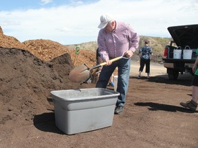 Rigo Jascher collects compost that he plans to use to plant potatoes with his wife.