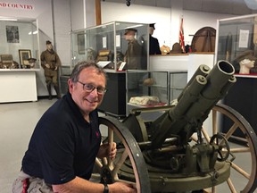 Bob Ion, of the Canadian Military Heritage Museum, with a First World War German light trench mortar, one of two captured at Vimy Ridge in 1917 and now on display at the museum. (Vincent Ball/The Expositor)