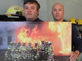 Vincent Ball/The Expositor
Brant County firefighters Mike Campbell (left) and Adam Steenburg, of the Cainsville station, are organizing a memorial benefit in honour of Brant County fire department District Chief Troy Cummerson who died of cancer in March. Cummerson is the firefighter in the white helmet at the extreme right of the photo Campbell and Steenburg are holding.
