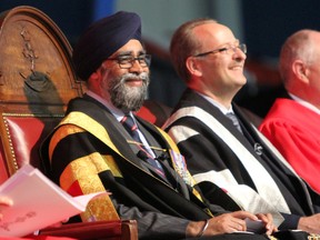 Minister of National Defence Harjit Sajjan listens to Brig.-Gen. Sebastien Bouchard speech at Royal Military College's 111th convocation ceremony, held at the Kingston Military Community Sports Centre on Thursday. (Steph Crosier/The Whig-Standard)