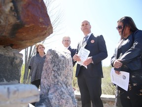 Sudbury NDP candidate Jamie West speaks about the NDP's indigenous platform, as Timmins-James Bay MP Charlie Angus and others look on at the Apology Cairn at Laurentian University on Thursday. Gino Donato/Sudbury Star/Postmedia Network