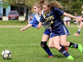 Pain Court Patriotes' Alexa Arbour (14) and Ridgetown Royals' Gillian Krekewich battle for the ball during the second half of an LKSSAA senior girls' soccer game at Ecole Secondaire de Pain Court in Pain Court, Ont., on Thursday, May 17, 2018. (MARK MALONE/Chatham Daily News/Postmedia Network)