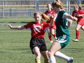 Emma Jennings, of the Chippewa Raiders, works to get by West Ferris Trojans defender Shalyn Bartraw during first-half NDA girls varsity soccer action at the Steve Omischl Sports Fields Complex, Thursday. Chippewa won 5-0 with Madison Barnes scoring a hat trick while Emma l'Ami provided a pair. Jennings, the regular goalkeeper, returned to the net for the second half to preserve the shutout. Dave Dale / The Nugget