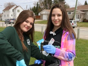 O’Gorman High School students Alyssa Curtis-Garito, left, and Kristina Beard were among a couple of dozen students who spent part of Friday afternoon picking up litter at the Flintstone Park  on Rea Street North. Teacher Anna MacDonnell said part of the exercise was to give students a spiritual appreciation of the outdoors.