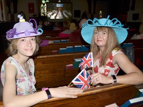 Fawn Carter, right and her daughter Teagan Serrick, 14, sport their homemade fascinators and hold British flags during a viewing of the royal wedding of Prince Harry and Meghan Markle at St. George's Anglican Church in Owen Sound early Saturday morning. (Rob Gowan The Sun Times)