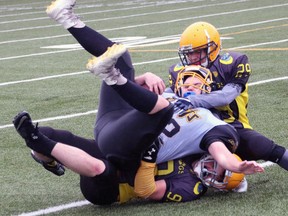 The North Bay Bulldogs bantam and junior varsity teams lost their 2018 Ontario Provincial Football League season-openers at the Steve Omischl Sports Fields Complex, Saturday, as the visiting Clarington Knights won 26-12 and 24-0, respectively.  In the photo above, junior varsity Bulldogs Christian Huter (29) and Miguel Allard (99) team up to take down a Knights ball carrier. Dave Dale / The Nugget