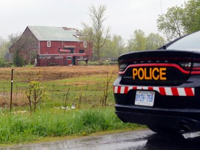 A Napanee OPP cruiser sits on Blessington Road at the farm from which horses were removed Saturday east of Blessington. Police had laid no further charges as of Monday and said the relocation of the remaining horses is expected to involve the help of the animals' owner.