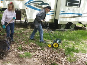 Susan Devitt and her partner, Scott Merrill, clean up their site at C.M. Wilson Conservation Area on Monday. (Trevor Terfloth/The Daily News)