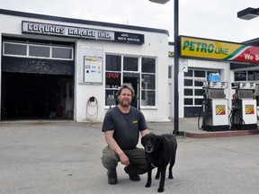 Doug Edmunds, with his dog Dakota, will be finished operating the family-owned full service gas station in Mitchell, Edmunds Garage, as of this Friday, May 25. The third generation business has been a mainstay in Mitchell since 1932.  ANDY BADER/MITCHELL ADVOCATE