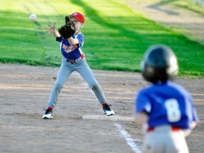 Abigayle Van Bakel at first base for one of the Mitchell Rookie baseball teams makes a catch while this batter hustles down the line during action from last Wednesday, May 16 at Keterson Park. ANDY BADER/MITCHELL ADVOCATE