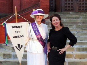Jean Hewitt, left, poses as a suffragette next to Stacy Smith from the cast of Ladies of the CNR as they stand together in front of Stratford city hall near the star of Agnes Macphail in 2016. (File photo/handout)
